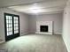 Comfortable living room with a tiled fireplace, carpeted floors, and access to the backyard through glass doors at 3589 Burlingham Dr, Lithonia, GA 30038