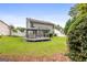 Well-manicured backyard with a lush green lawn, deck, and mature trees for privacy at 320 Cloverwood Drive, Fayetteville, GA 30215