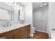 Modern bathroom featuring double vanity with wood cabinets and brushed silver hardware at 320 Cloverwood Drive, Fayetteville, GA 30215