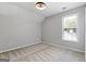 Light filled bedroom features a vaulted ceiling, carpet and large window with a backyard view at 320 Cloverwood Drive, Fayetteville, GA 30215