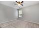 Comfortable bedroom featuring carpet, a ceiling fan, and a view of the backyard at 320 Cloverwood Drive, Fayetteville, GA 30215