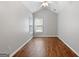 Neutral bedroom featuring hardwood floors, two windows, and a ceiling fan at 320 Cloverwood Drive, Fayetteville, GA 30215