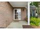 Close-up of a cozy brick porch with a swing, perfect for enjoying the outdoors at 320 Cloverwood Drive, Fayetteville, GA 30215