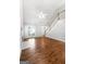 Living room showcasing high ceilings, fireplace, staircase, and hardwood floors at 320 Cloverwood Drive, Fayetteville, GA 30215