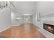 Open-concept living area with a fireplace, dining space, and modern lighting at 320 Cloverwood Drive, Fayetteville, GA 30215