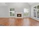 Spacious living room featuring a fireplace, natural light, and hardwood floors at 320 Cloverwood Drive, Fayetteville, GA 30215