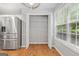 Walk-in pantry features adjustable shelving, and located next to stainless steel refrigerator and light filled window at 320 Cloverwood Drive, Fayetteville, GA 30215
