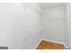 Spacious walk-in closet offering ample storage with installed shelving and wood floors at 320 Cloverwood Drive, Fayetteville, GA 30215