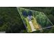 Aerial view of property lines surrounding a charming one-story home enveloped by mature trees and green grass at 315 Antioch Road, Mcdonough, GA 30252