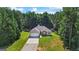 Aerial view of the property showcasing the home, surrounding trees, and lush green lawn at 315 Antioch Road, Mcdonough, GA 30252