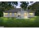 Back exterior of home with multiple windows and a patio, all surrounded by a green lawn at 315 Antioch Road, Mcdonough, GA 30252