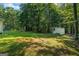 Large backyard with shed, mature trees, and green grass at 315 Antioch Road, Mcdonough, GA 30252