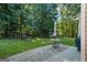 Large backyard with patio, outdoor seating, and a swing set among the surrounding trees at 315 Antioch Road, Mcdonough, GA 30252