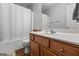 Neutral bathroom featuring wood cabinet vanity and a tub shower with a shower curtain at 315 Antioch Road, Mcdonough, GA 30252