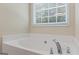 Corner view of the luxurious, bright bathtub with chrome faucet at 315 Antioch Road, Mcdonough, GA 30252