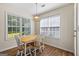 Cozy dining area with natural light, wood floors, and a view to the backyard at 315 Antioch Road, Mcdonough, GA 30252