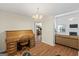 Open living room with a fireplace, desk, and couches with wood floors and large windows at 315 Antioch Road, Mcdonough, GA 30252