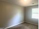 Neutral bedroom with textured ceilings, window, and carpet at 4263 Southvale Dr, Decatur, GA 30034