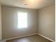 Neutral bedroom with textured ceilings, window, and carpet at 4263 Southvale Dr, Decatur, GA 30034