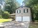 Two-story home featuring a two-car garage, brick accents, and lush green lawn at 4263 Southvale Dr, Decatur, GA 30034