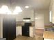 Kitchen with white cabinets, black appliances, a window, and neutral paint at 4263 Southvale Dr, Decatur, GA 30034