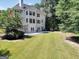 Spacious backyard features a walk-out patio, mature trees, and a well-maintained lawn at 100 Castlebrook Chase, Tyrone, GA 30290