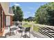 View of the decorative white railing and furniture on the balcony of the home overlooking the front yard at 100 Castlebrook Chase, Tyrone, GA 30290