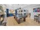 Basement featuring a pool table, fireplace, blue cabinets, and a small dining area at 100 Castlebrook Chase, Tyrone, GA 30290