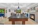 Finished basement featuring a pool table, fireplace, and a walkout to the backyard at 100 Castlebrook Chase, Tyrone, GA 30290