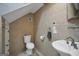 Small bathroom featuring tile, a pedestal sink, toilet and a towel rack at 100 Castlebrook Chase, Tyrone, GA 30290