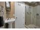 Tiled bathroom featuring a stand-up shower with a glass door and a modern vanity at 100 Castlebrook Chase, Tyrone, GA 30290