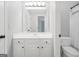 Bathroom featuring a white vanity with a sink, toilet, and an adjacent doorway at 100 Castlebrook Chase, Tyrone, GA 30290