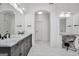 Bright primary bathroom features double vanity, makeup vanity, frameless shower, and tub at 100 Castlebrook Chase, Tyrone, GA 30290
