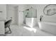 Bright bathroom featuring marble floors, glass shower, soaking tub, and a modern vanity at 100 Castlebrook Chase, Tyrone, GA 30290