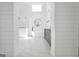 Bright bathroom showcasing marble floors, glass shower, soaking tub, and a vanity with a stone countertop at 100 Castlebrook Chase, Tyrone, GA 30290