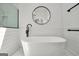 Elegant bathroom featuring a modern soaking tub, sleek black fixtures, and stylish round mirror at 100 Castlebrook Chase, Tyrone, GA 30290