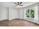 Bright bedroom with a window view, a double door closet, and modern ceiling fan at 100 Castlebrook Chase, Tyrone, GA 30290