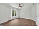 Cozy bedroom with hardwood floors, natural light, and ceiling fan at 100 Castlebrook Chase, Tyrone, GA 30290