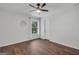Simple bedroom featuring hardwood floors, ceiling fan, and a single window at 100 Castlebrook Chase, Tyrone, GA 30290