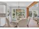 Sunlit dining room with large windows and a round table for six at 100 Castlebrook Chase, Tyrone, GA 30290