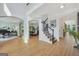 Elegant foyer boasts hardwood floors, high ceilings, staircase, and views of multiple rooms at 100 Castlebrook Chase, Tyrone, GA 30290