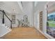 Bright foyer showcases hardwood floors, a staircase, and a view of the entryway at 100 Castlebrook Chase, Tyrone, GA 30290
