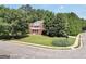 Charming red brick two-story home with well-manicured lawn and inviting front porch at 100 Castlebrook Chase, Tyrone, GA 30290