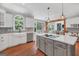 Bright kitchen features white cabinets, stainless steel appliances, and a center island with cooktop at 100 Castlebrook Chase, Tyrone, GA 30290