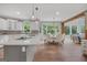 Open concept kitchen showcasing a center island with cooktop, white cabinetry, and a breakfast nook at 100 Castlebrook Chase, Tyrone, GA 30290