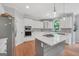 Bright, modern kitchen with stainless steel appliances and a large center island with cooktop at 100 Castlebrook Chase, Tyrone, GA 30290
