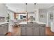 Open concept kitchen with stainless appliances, center island cooktop, and view to the dining area at 100 Castlebrook Chase, Tyrone, GA 30290