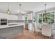 Bright kitchen featuring white cabinetry, stainless steel appliances, and a breakfast nook with natural light at 100 Castlebrook Chase, Tyrone, GA 30290