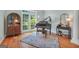 Elegant living room features a grand piano, hardwood floors, and abundant natural light at 100 Castlebrook Chase, Tyrone, GA 30290