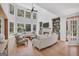Living room boasts high ceilings, large windows, and a cozy fireplace at 100 Castlebrook Chase, Tyrone, GA 30290
